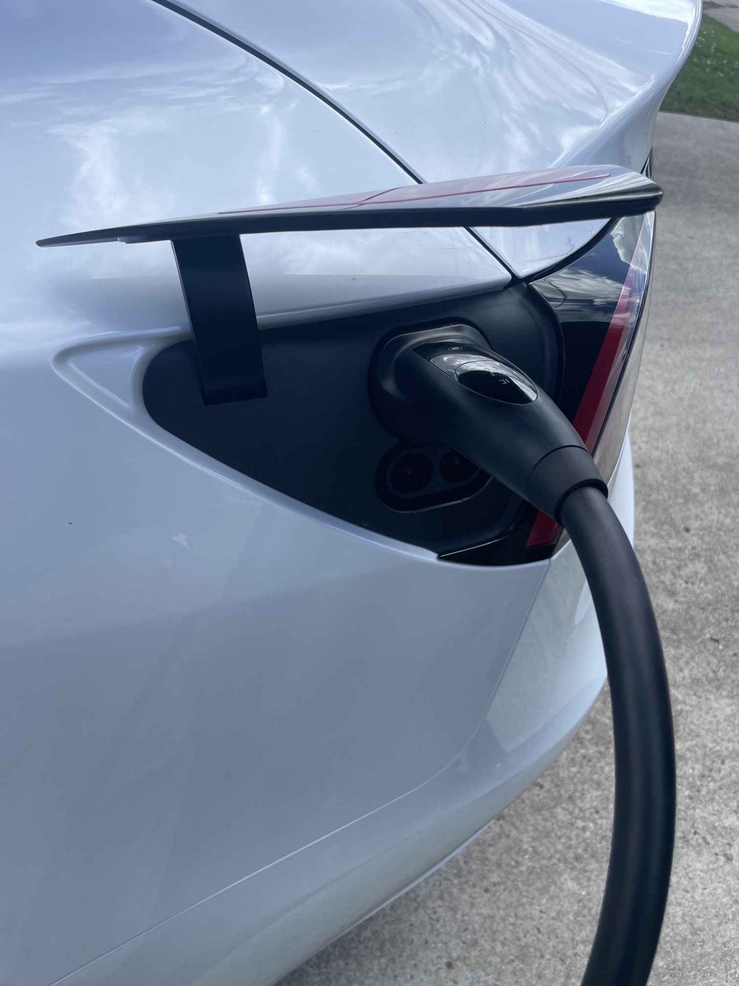 Ev Charger Plugging Into Tesla